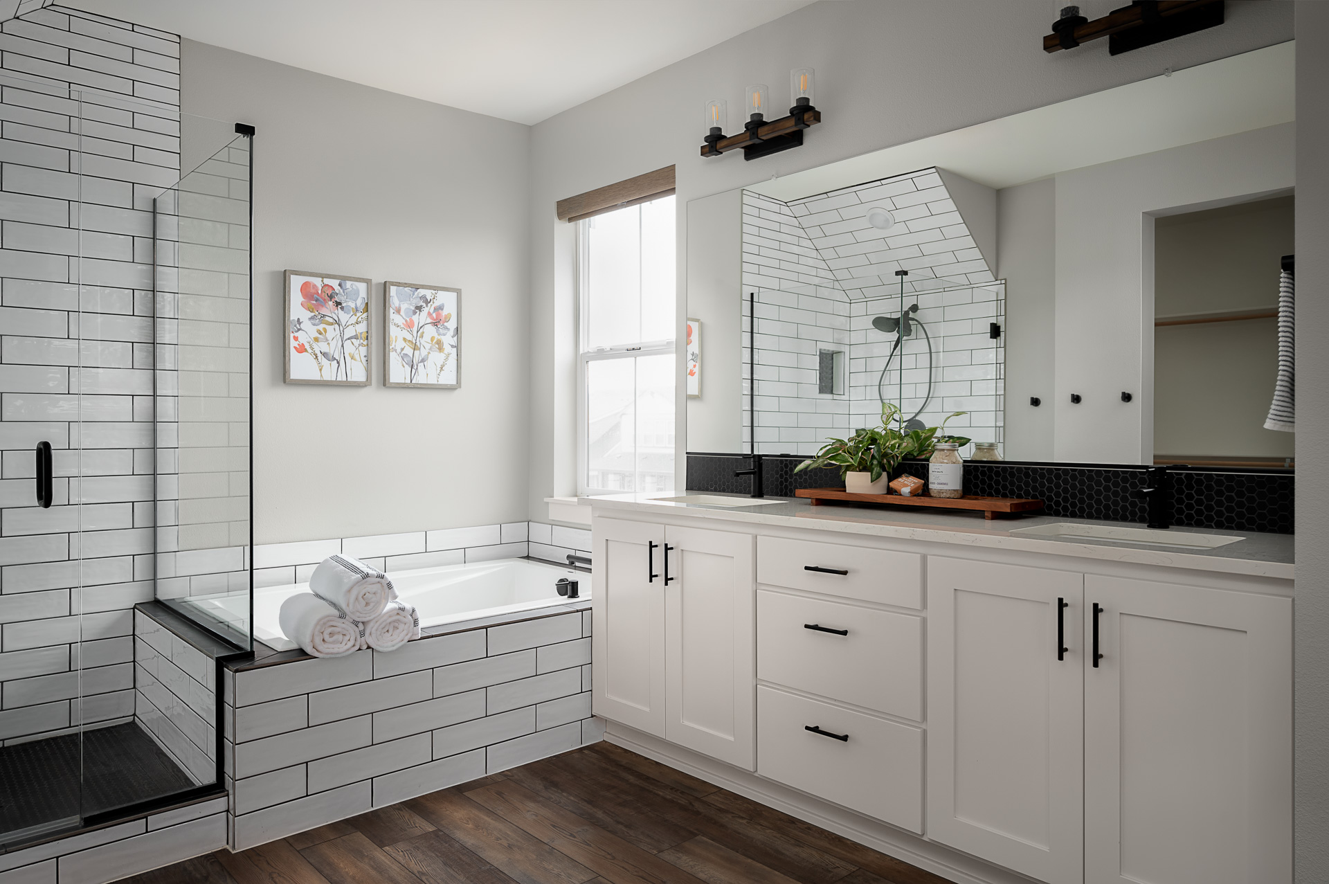 A bright modern bathroom with large white tiles.