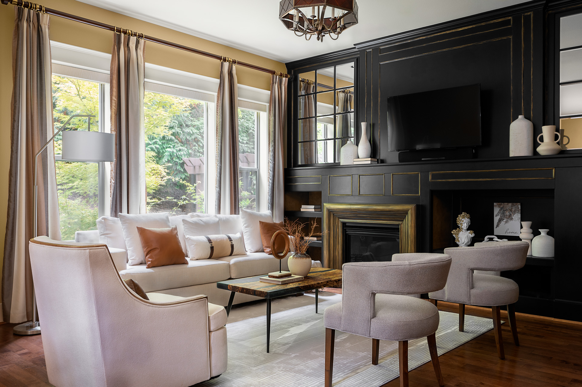 Modern and elegant living room with fireplace and floor to ceiling windows.